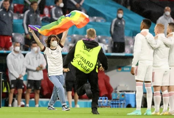 Fan is running on the field of play with a rainbow flag during the UEFA Euro 2020 Championship Group F match between Germany and Hungary at Allianz...