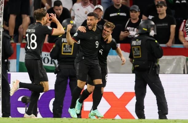 Leon Goretzka of germany celebrates as he scores the goal 2:2 in direction to the hungarian Fans with Kevin Volland of germany and Joshua Kimmich of...