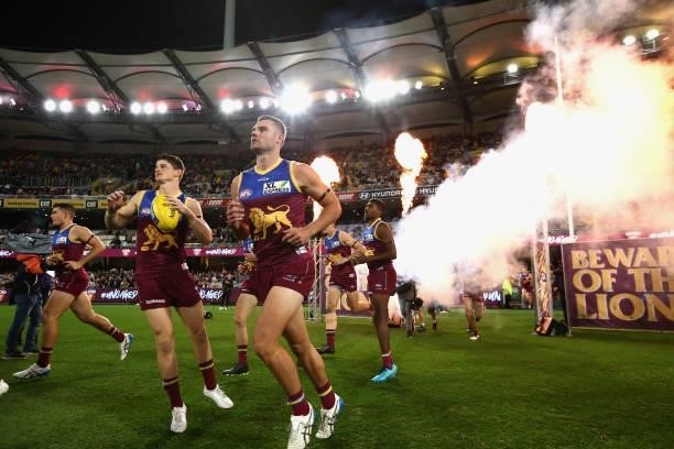 The Lions run out during the round 14 AFL match between the Brisbane Lions and the Geelong Cats at The Gabba on June 24, 2021 in Brisbane, Australia.