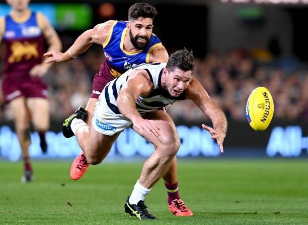 Tom Hawkins of the Cats is pressured by the defence during the round 14 AFL match between the Brisbane Lions and the Geelong Cats at The Gabba on...