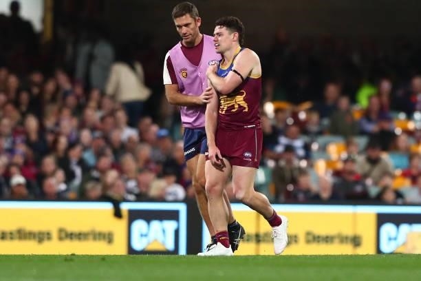 Lachie Neale of the Lions leaves the field injured during the round 14 AFL match between the Brisbane Lions and the Geelong Cats at The Gabba on June...