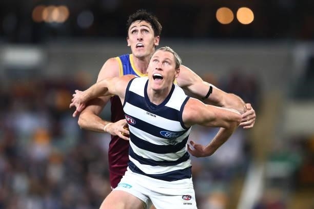Oscar McInerney of the Lions and Mark Blicavs of the Cats compete for the ball during the round 14 AFL match between the Brisbane Lions and the...