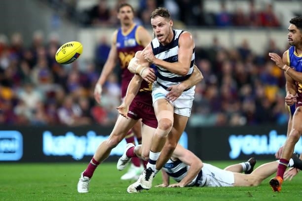 Jake Kolodjashnij of the Cats handballs during the round 14 AFL match between the Brisbane Lions and the Geelong Cats at The Gabba on June 24, 2021...