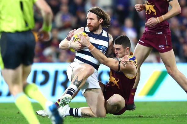 Zach Tuohy of the Cats is tackled during the round 14 AFL match between the Brisbane Lions and the Geelong Cats at The Gabba on June 24, 2021 in...