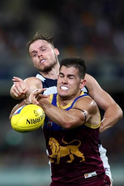 Brandon Starcevich of the Lions competes with Jake Kolodjashnij of the Cats during the round 14 AFL match between the Brisbane Lions and the Geelong...