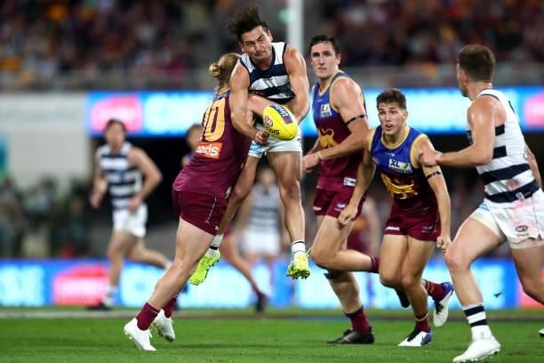 Luke Dahlhaus of the Cats is tackled during the round 14 AFL match between the Brisbane Lions and the Geelong Cats at The Gabba on June 24, 2021 in...