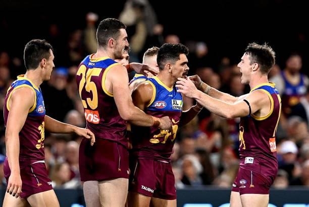 Charlie Cameron of the Lions is congratulated by team mates after kicking a goal during the round 14 AFL match between the Brisbane Lions and the...