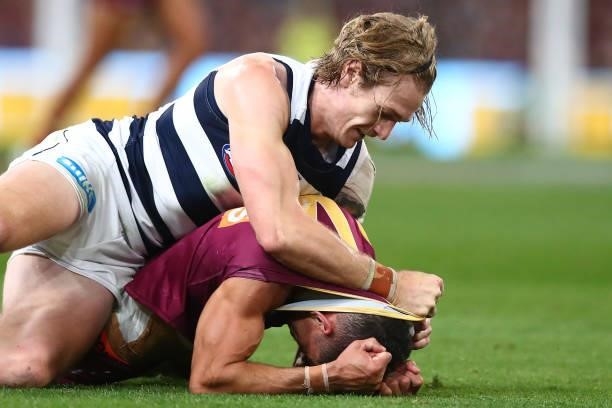 Tom Stewart of the Cats wrestles Charlie Cameron of the Lions during the round 14 AFL match between the Brisbane Lions and the Geelong Cats at The...