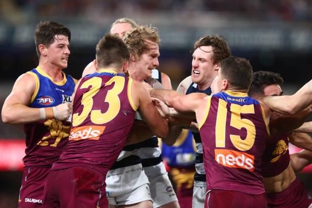 Players grapple during the round 14 AFL match between the Brisbane Lions and the Geelong Cats at The Gabba on June 24, 2021 in Brisbane, Australia.