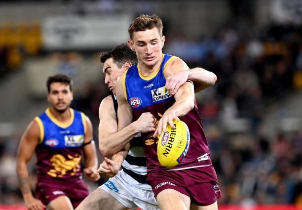 Harris Andrews of the Lions is pressured by the defence of Jeremy Cameron of the Cats during the round 14 AFL match between the Brisbane Lions and...
