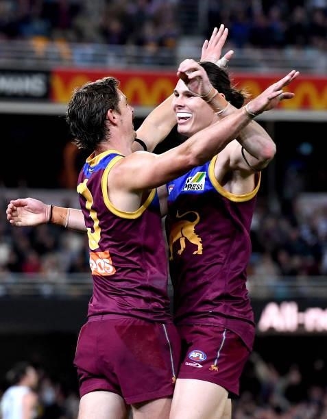Joe Daniher of the Lions celebrates with team mates Eric Hipwood after kicking a goal during the round 14 AFL match between the Brisbane Lions and...