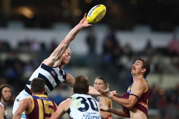 Mark Blicavs of the Cats gets a touch during the round 14 AFL match between the Brisbane Lions and the Geelong Cats at The Gabba on June 24, 2021 in...