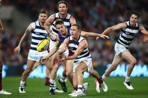 Joel Selwood of the Cats handballs during the round 14 AFL match between the Brisbane Lions and the Geelong Cats at The Gabba on June 24, 2021 in...