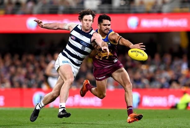 Charlie Cameron of the Lions and Jed Bews of the Cats challenge for the ball during the round 14 AFL match between the Brisbane Lions and the Geelong...