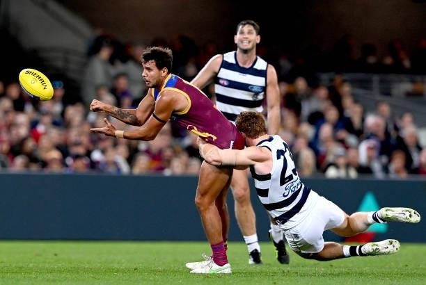 Callum Ah Chee of the Lions gets a handball away during the round 14 AFL match between the Brisbane Lions and the Geelong Cats at The Gabba on June...