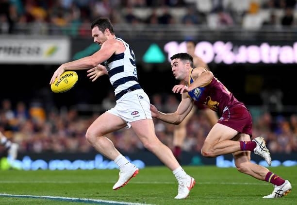 Patrick Dangerfield of the Cats breaks away from the defence during the round 14 AFL match between the Brisbane Lions and the Geelong Cats at The...