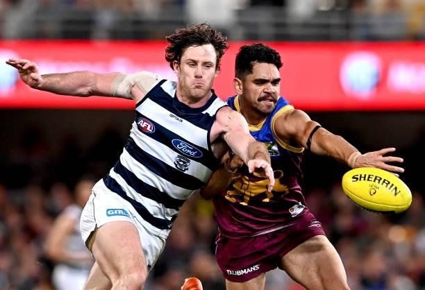 Charlie Cameron of the Lions and Jed Bews of the Cats challenge for the ball during the round 14 AFL match between the Brisbane Lions and the Geelong...
