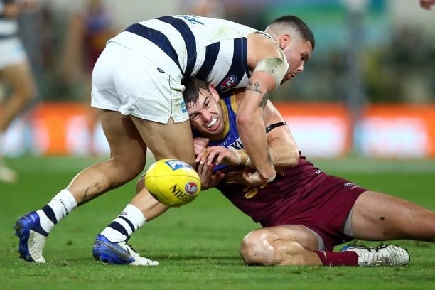 Jarryd Lyons of the Lions handballs during the round 14 AFL match between the Brisbane Lions and the Geelong Cats at The Gabba on June 24, 2021 in...
