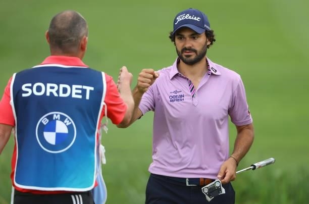 Clement Sordet of France fist pumps his caddie on the last green as he finishes his first round of The BMW International Open at Golfclub Munchen...