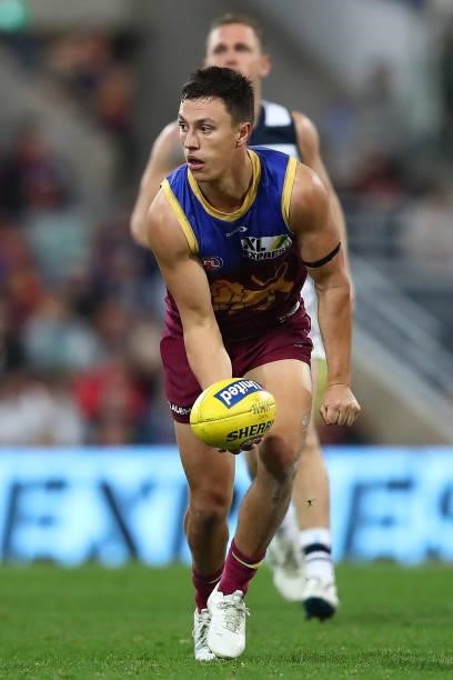 Hugh McCluggage of the Lions handballs during the round 14 AFL match between the Brisbane Lions and the Geelong Cats at The Gabba on June 24, 2021 in...
