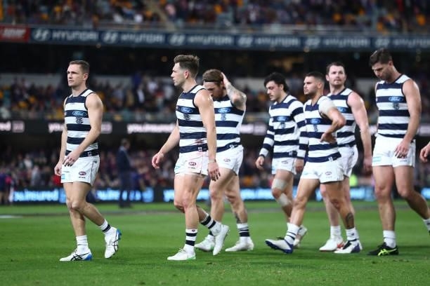 Joel Selwood and the Cats leave the field at half time during the round 14 AFL match between the Brisbane Lions and the Geelong Cats at The Gabba on...