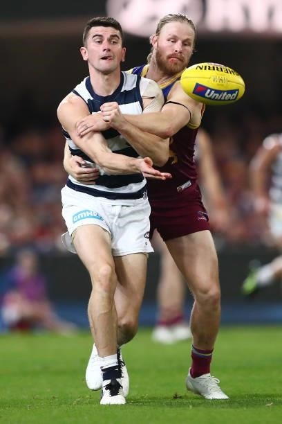 Mark O'Connor of the Cats handballs during the round 14 AFL match between the Brisbane Lions and the Geelong Cats at The Gabba on June 24, 2021 in...