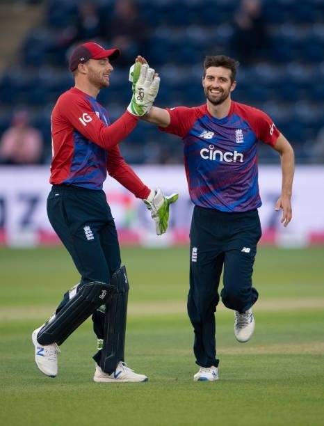England bowler Mark Wood celebrates with team mate Jos Buttler after taking the wicket of Dhananjaya de Silva of Sri Lanka during the 1st T20I...