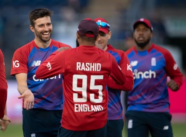 England bowler Mark Wood celebrates with team mate Adil Rashid after he takes a catch off Wood's bowling to dismiss Dhananjaya de Silva of Sri Lanka...