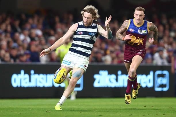 Cameron Guthrie of the Cats kicks during the round 14 AFL match between the Brisbane Lions and the Geelong Cats at The Gabba on June 24, 2021 in...