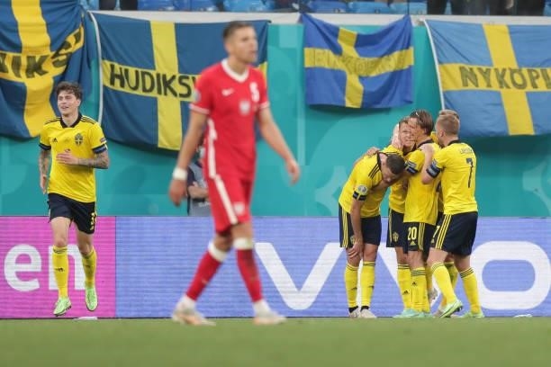Viktor Claesson of Sweden celebrates scoring their third goal wit teammates as Jan Bednarek of Poland looks dejected during the UEFA Euro 2020...