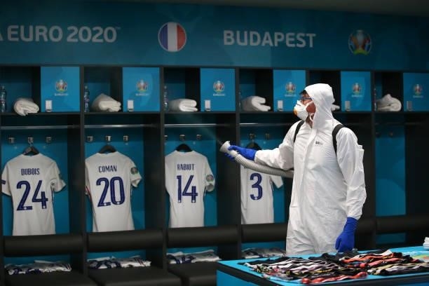 Worker sanitises the France team dressing room prior to the UEFA Euro 2020 Championship Group F match between Portugal and France at Puskas Arena on...