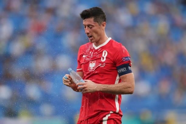 Robert Lewandowski of Poland refreshes himself with water during the UEFA Euro 2020 Championship Group E match between Sweden and Poland at Saint...