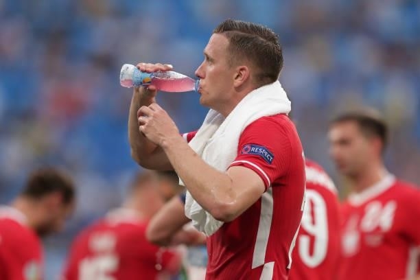 Piotr Zielinski of Poland refreshes himself with water during the UEFA Euro 2020 Championship Group E match between Sweden and Poland at Saint...