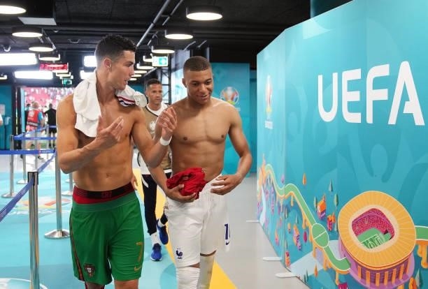 Cristiano Ronaldo of Portugal speaks with Kylian Mbappe of France in the tunnel following the UEFA Euro 2020 Championship Group F match between...