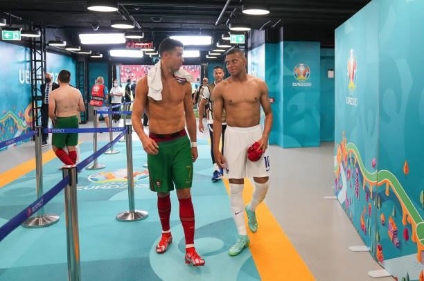 Cristiano Ronaldo of Portugal speaks with Kylian Mbappe of France in the tunnel following the UEFA Euro 2020 Championship Group F match between...