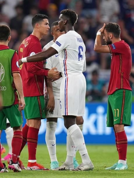 Cristiano Ronaldo of Portugal interacts with Paul Pogba and Kylian Mbappe of France after the UEFA Euro 2020 Championship Group F match between...