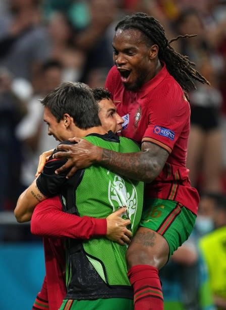 Cristiano Ronaldo of Portugal celebrates Renato Sanches and Joao Palhinha after scoring their side's first goal during the UEFA Euro 2020...
