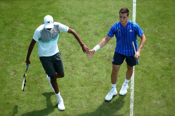 Joe Salisbury of Great Britain and team mate Rajeev Ram of USA high five during their quarter final mens doubles match against John Peers and...