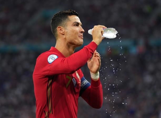 Cristiano Ronaldo of Portugal refreshes prior to during the UEFA Euro 2020 Championship Group F match between Portugal and France at Puskas Arena on...