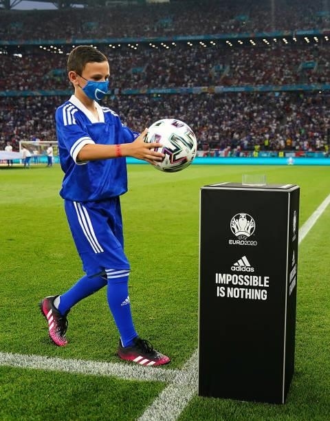 The official match ball carrier puts the ball on the plinth prior to the UEFA Euro 2020 Championship Group F match between Portugal and France at...