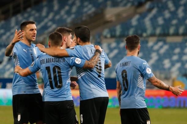 Luis Suarez of Uruguay and teammates celebrate the first goal of their team scored by an own goal from Carlos Lampe of Bolivia during a Group A match...