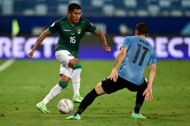 Erwin Saavedra of Bolivia controls the ball against Matias Viña of Uruguay during a Group A match between Bolivia and Uruguay as part of Copa America...