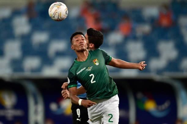 Jairo Quinteros of Bolivia heads the ball against Luis Suarez of Uruguay during a Group A match between Bolivia and Uruguay as part of Copa America...