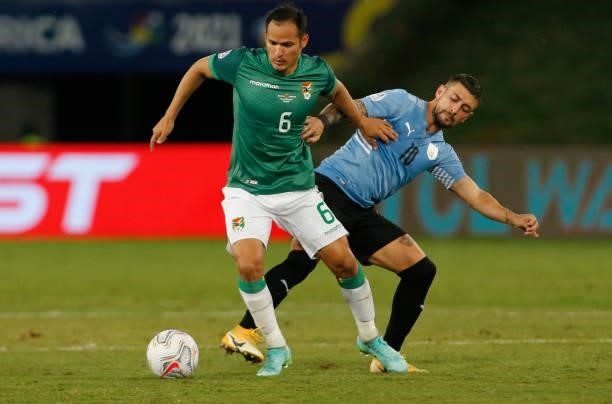 Leonel Justiniano of Bolivia fights for the ball with Giorgian De Arrascaeta of Uruguay during a Group A match between Bolivia and Uruguay as part of...