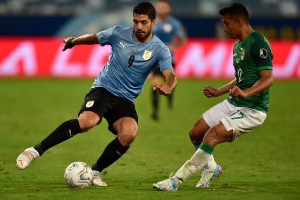 Luis Suarez of Uruguay fights for the ball with Roberto Fernandez of Bolivia during a Group A match between Bolivia and Uruguay as part of Copa...