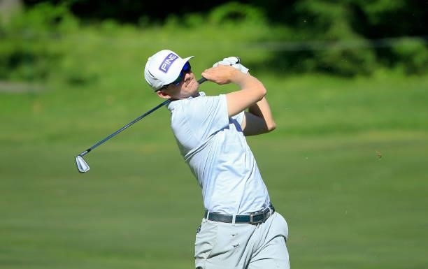 Jim Knous hits his second shot on the eighth hole during the first round of the Live And Work In Maine Open held at Falmouth Country Club on June 24,...