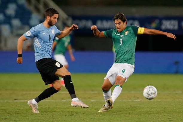 Rodrigo Bentancur of Uruguay kicks the ball against Marcelo Moreno of Bolivia during a Group A match between Bolivia and Uruguay as part of Copa...