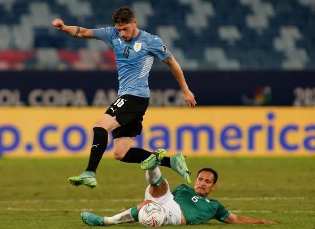 Facundo Torres of Uruguay jumps over Leonel Justiniano of Bolivia during a Group A match between Bolivia and Uruguay as part of Copa America Brazil...
