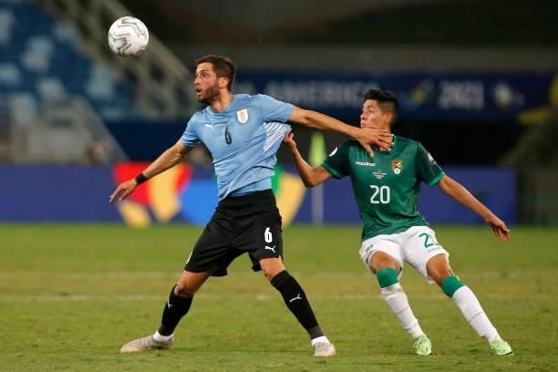 Rodrigo Bentancur of Uruguay fights for the ball with Ramiro Vaca of Bolivia during a Group A match between Bolivia and Uruguay as part of Copa...