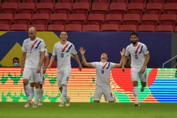 Braian Samudio of Paraguay celebrates with teammates after scoring the first goal of his team during a Group A match between Chile and Paraguay as...